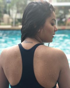 Nidhi Jha tattoo Karma on her back.
