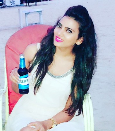 Anupama Prakash with a bottle of beer
