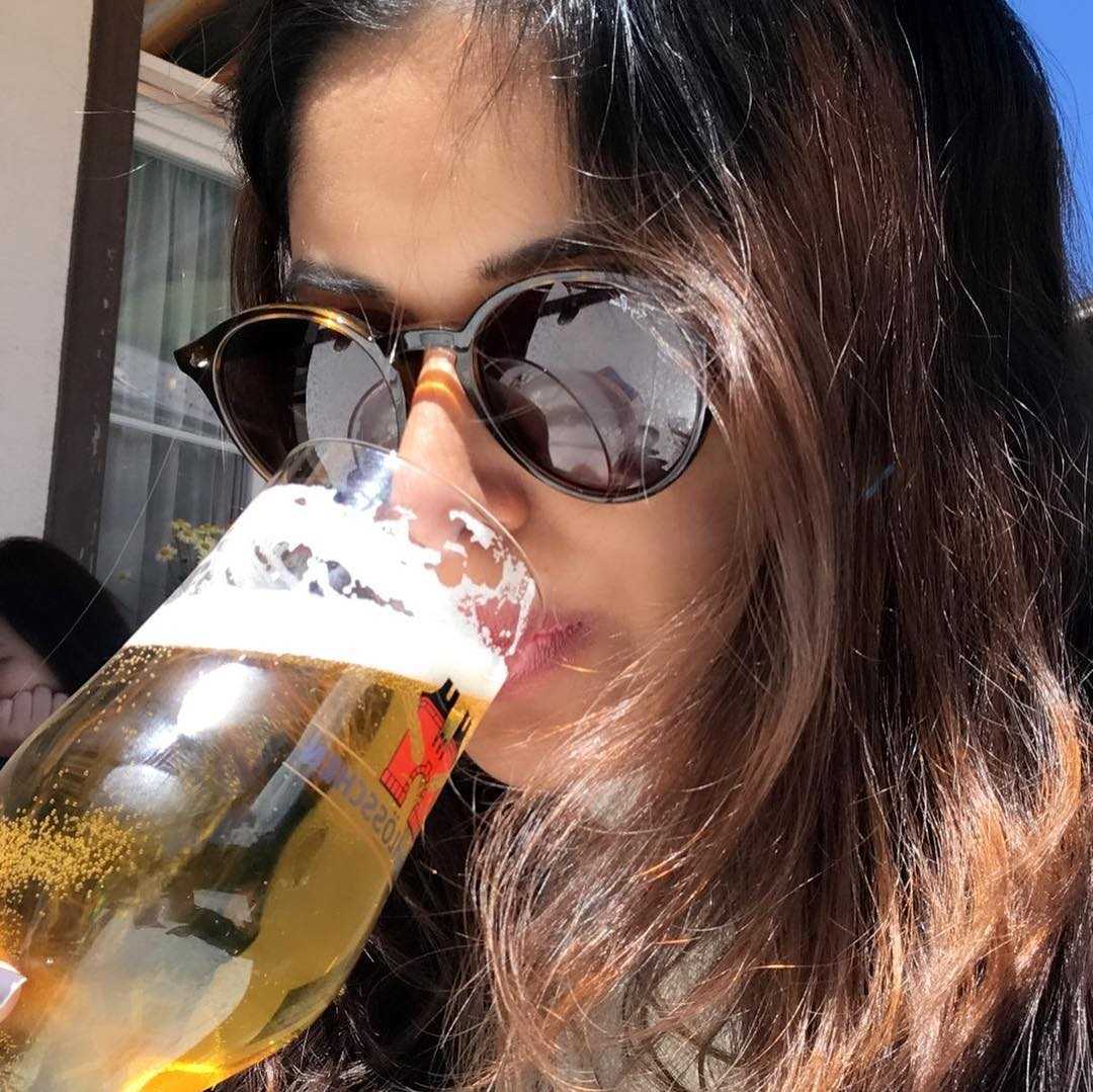 Sneha Paul with a glass of alcohol