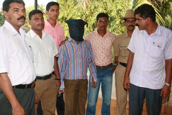 Mohan Kumar being escorted by the cops to a court