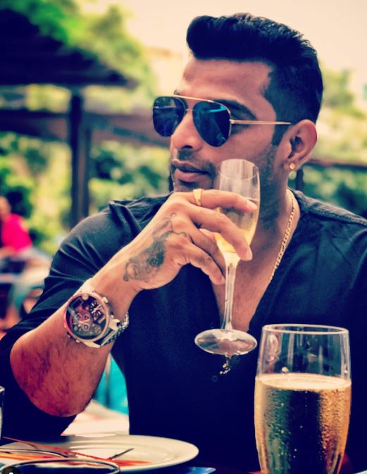 Vinay Gowda with the glass of alcohol